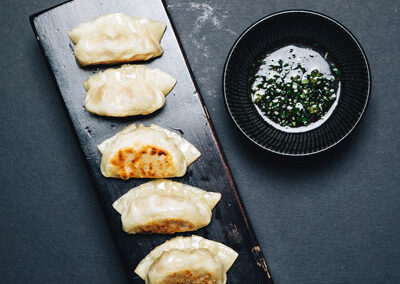 Gyoza (pot stickers) with red rice vinegar dipping sauce and sesame chilli paste