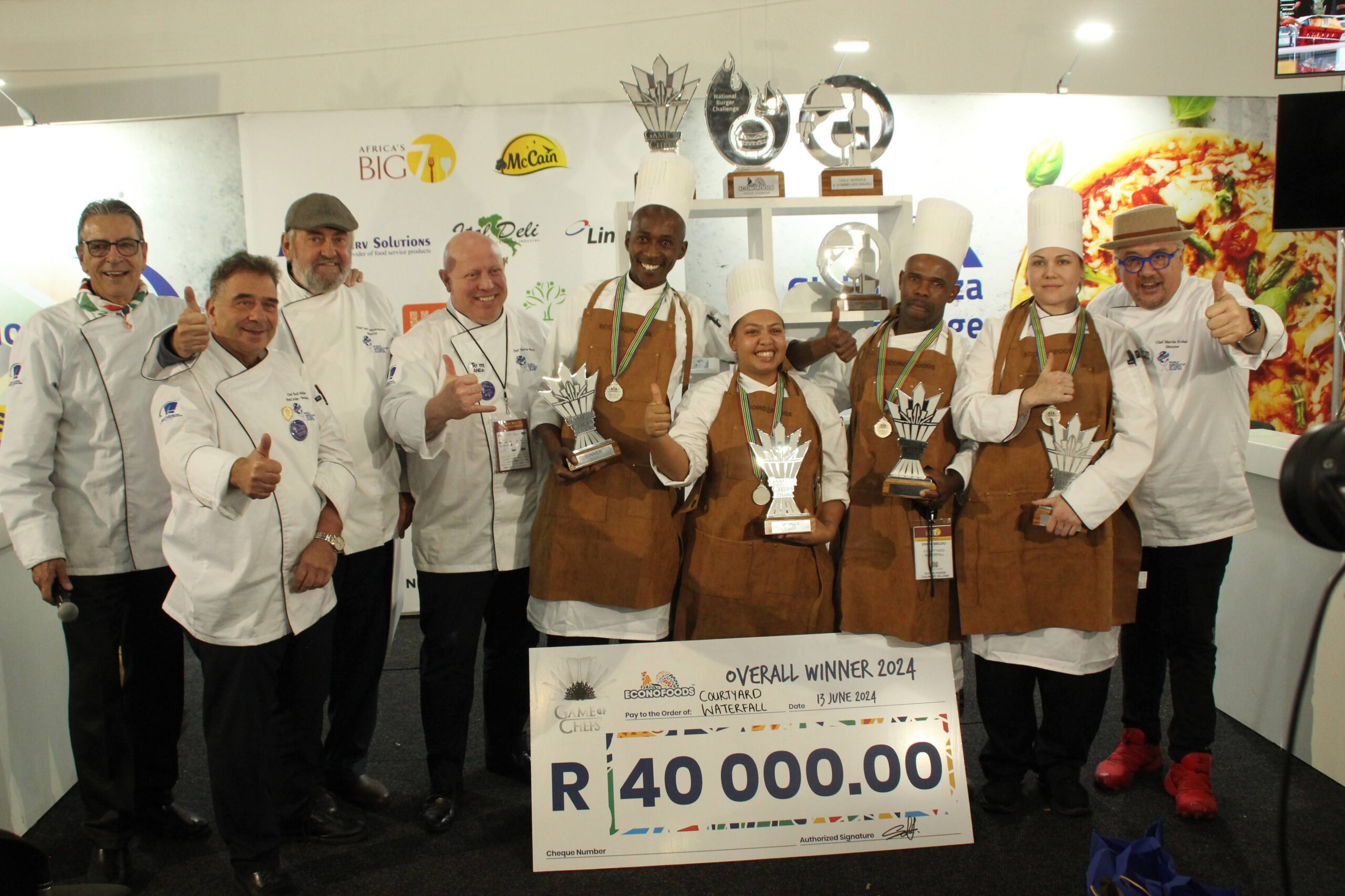 Winning team with judges, organiser and emcee